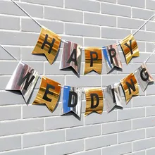 Banderines Happy Wedding con acabado espejo dorado y plateado colgados en una pared