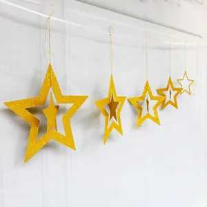 Detail of gold glitter hollow star ornaments for festive party ceiling decorations