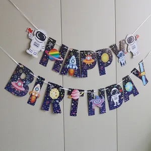 Close-up of Happy Birthday space theme banner with astronauts and rocket illustrations
