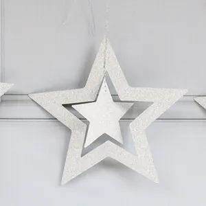 Close-up of silver glitter nested hollow star pendant for festive party ceiling decoration