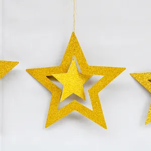 Close-up of golden glitter hollow star decorations with double-layer design for party
