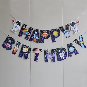 Close-up of Happy Birthday banner with astronaut and planet cards for space themed party