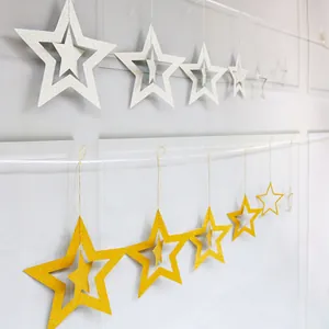 Close-up of gold and silver glittered double-layer hollow star hanging party decorations