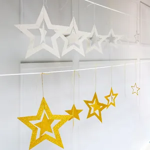 Detail of hanging hollow star decorations with silver and gold glitter finish for parties