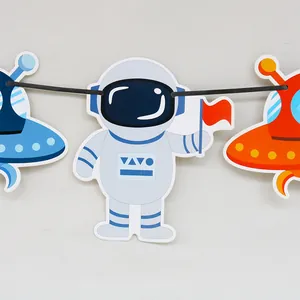 Detail of space-themed party banner with astronaut and UFO cardstock decorations