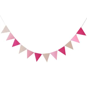 Detail of pink and cream triangular bunting banner flags on a white string for party decor