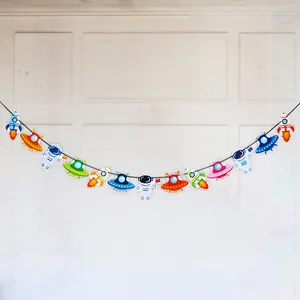 Close-up of colorful astronaut, rocket, and UFO banner flags for space themed parties