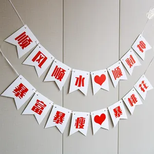 Chinese party banner with festive red blessing words on white fishtail flags