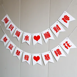 Close-up of Chinese swallowtail bunting flags with festive red blessings for prosperity