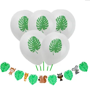 Detail view of jungle theme party banner with cartoon animals and leaf print balloons