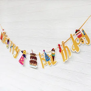 Gelbe Happy Birthday Girlande mit Cupcake-Motiven vor weißer Ziegelwand Dekoration