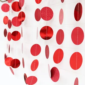 Detail of red glitter and mirror finish circular paper garland for party decorations