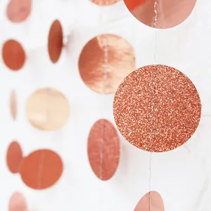 Close-up of glitter and mirror rose gold circular paper garland for party decoration