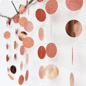 Detail of rose gold glitter and mirror finish circle paper garlands for party decor