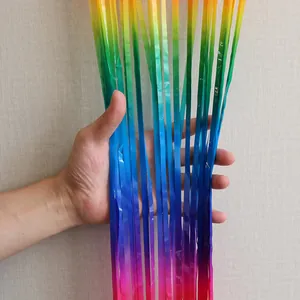 Close-up of rainbow gradient foil fringe curtain with metallic shine for party decor