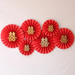 Detail of red wedding paper fans with gold glitter double happiness calligraphy
