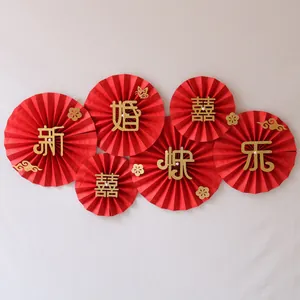 Detail view of 3D Chinese wedding paper fans with gold glitter calligraphy and floral patterns