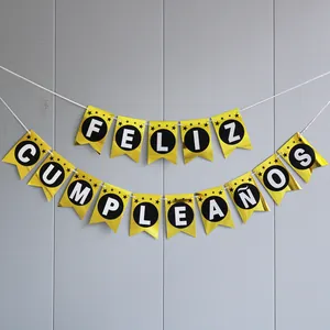 Detail of Feliz Cumpleaños mirror gold banner with black stars and round letters