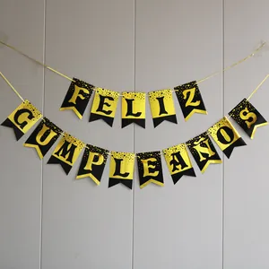 Detail of Feliz Cumpleaños banner with gold dots and metallic black swallowtail cards