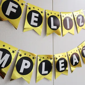Detail of mirror gold Feliz Cumpleaños birthday banner with black and white accents