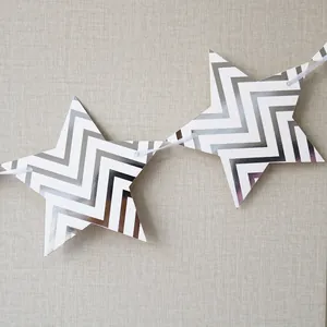 Detail of star-shaped bunting flags with silver wave pattern for party tent decoration