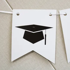 Close-up of white swallowtail card with black graduation cap design for 2025 party banner