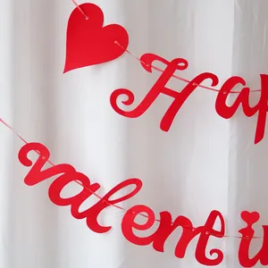 Detail of red Happy Valentine felt banner with heart cutouts for party wall decoration