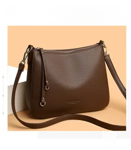 Detail of lychee pattern leather shoulder bag with silver hardware and tassel zip puller