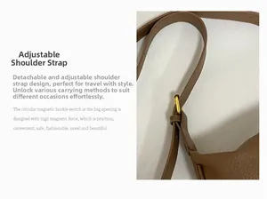 Detail of adjustable and detachable brown pebbled leather shoulder strap with gold buckle