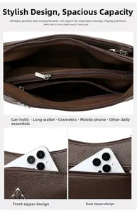 Detalle de bolso grande de cuero marrón con varios compartimentos y cierres externos