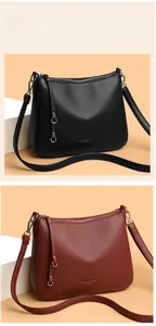 Detail of lychee pattern leather textures on black and burgundy luxury shoulder bags