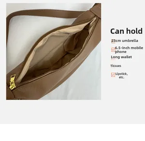Interior view of brown pebble leather crossbody bag showing spacious storage compartments