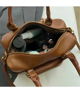 Detail view of large capacity interior for brown vintage leather boston handbag