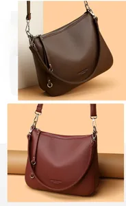Detailed macro view showing the textured lychee grain leather and silver hardware on Hobo bags