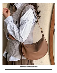 Close-up of brown litchi pattern leather Hobo bag with adjustable shoulder strap and zipper