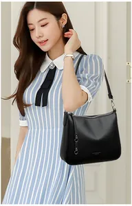 Detail of lychee pattern leather shoulder bag with silver hardware and zipper