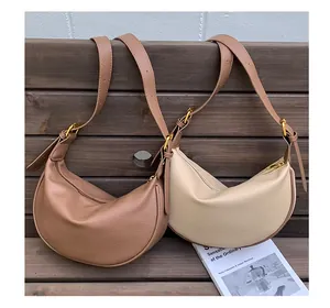 Detailed texture of brown and beige hobo bags made of soft lychee grain leather