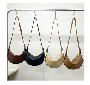Detail of four crescent moon bags in coffee, black, cream, and caramel lychee leather