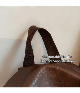 Gros plan sur la poignée en tissu marron foncé et la texture du cuir synthétique vintage