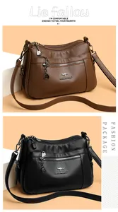 Detailed view of leather cross-body bags with multi-layer zippers and metallic kangaroo logo