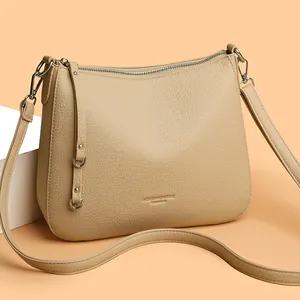 Beige lychee texture leather crescent shoulder bag with adjustable strap for women