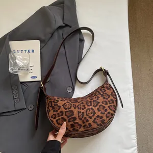 Retro faux suede leopard print crescent shoulder bag with brown leather strap and gold hardware