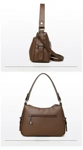 Detail view of brown pebbled leather handbag with rear zipper pocket and strap
