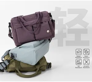 Water-repellent nylon crossbody bag with multiple pockets for daily commuting storage