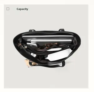 Top view of black tote bag interior showing spacious compartments and a 14-inch laptop