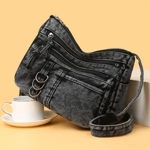 Retro washed black denim shoulder bag with multi-layer zippers and metal rings