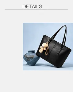 Close-up of black leather tote bag with a cute light brown plush bear charm detail