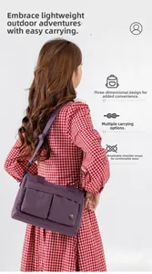 Detail of purple nylon crossbody bag featuring large capacity pockets and adjustable strap