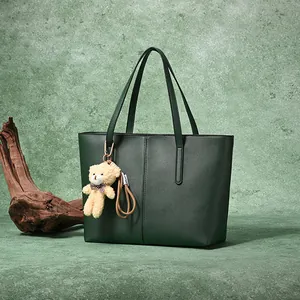 Large dark green leather tote bag with bear charm pendant for stylish women commute