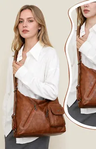 Macro detail of brown retro faux leather shoulder bag with zipper and front pocket design
